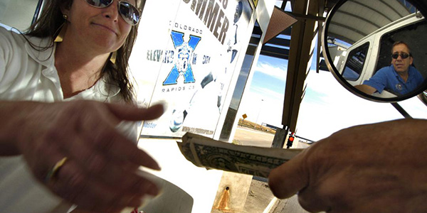 female toll booth worker accepting money