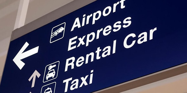 airport signage directing passengers to airport express, to rental car location and to taxi services