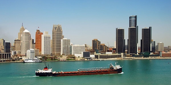 Aerial view of downtown Detroit, MI with a barge in the foreground