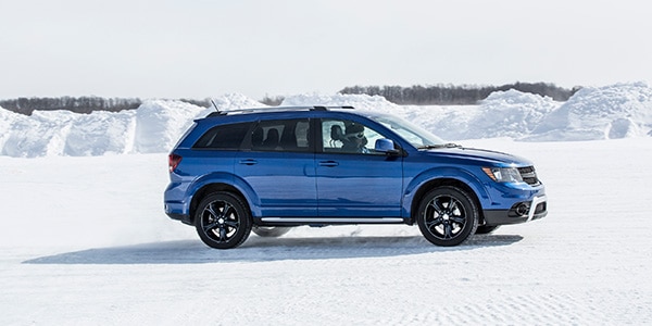 blue 2020 Dodge Journey surrounded by snow