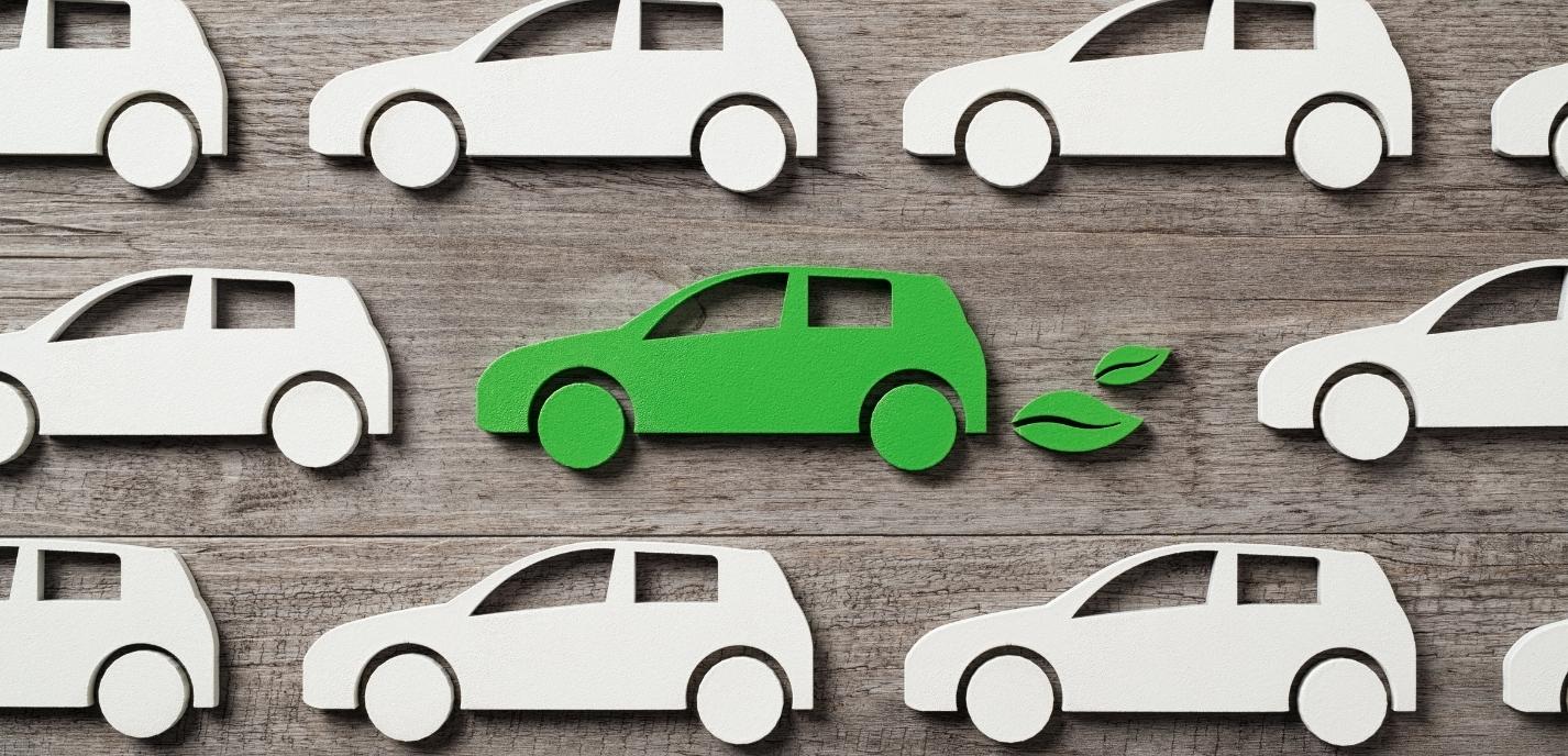 Car graphic of a green car with leaves surrounded by white cars, signifying a green or hybrid type car