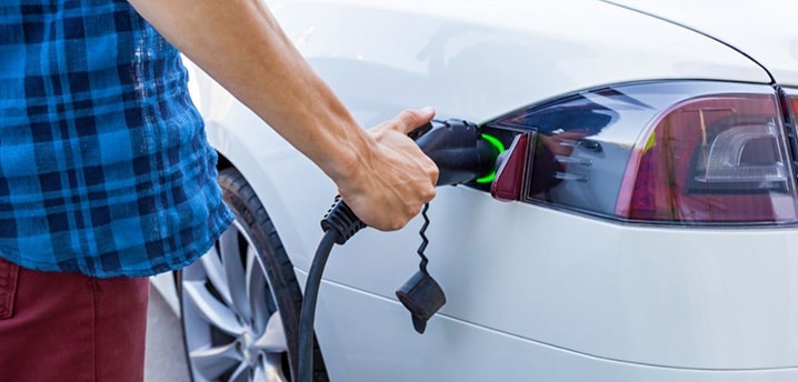 person charging their electric car