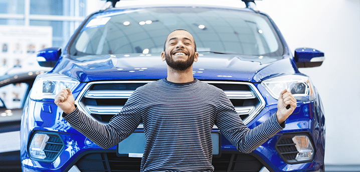 Guy in striped shirt excited about buying a new car | How To Save Money on a New Car