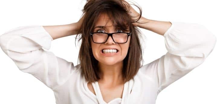 Frustrated woman with hands on her head