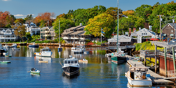 Fishing boats docked in a harbor off the coast of Maine | States with the best and worst credit scores