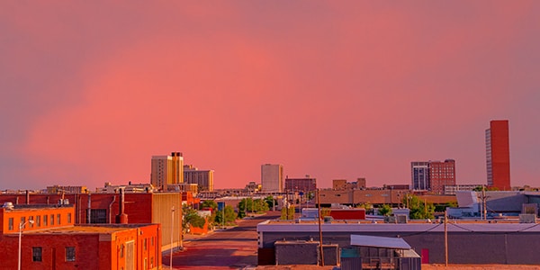 Brilliant pink and red sunset colors downtown Lubbock, Texas, overlooking the streets and buildings