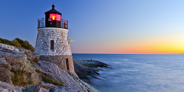 Lighthouse at night on a rocky Rhode Island shore| States Best and Worst Auto Refinance Rates