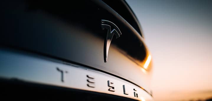 Close-up of the Tesla logo on the trunk of a Tesla car model X P100D