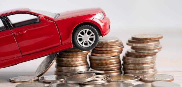 Toy car climbing up stacks of quarters