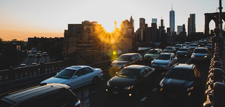 cars in traffic on a busy highway over a city