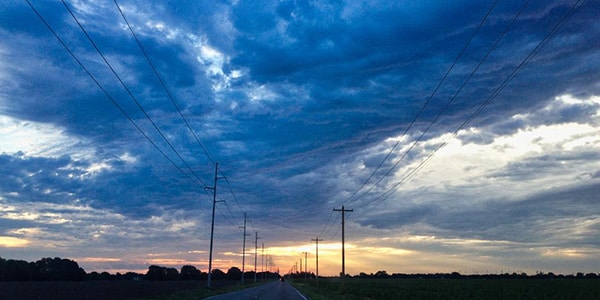 Electrical poles against an Arkansas blue sky