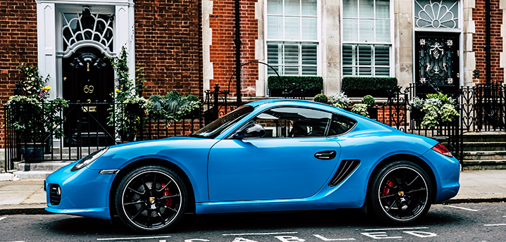 blue coupe on road