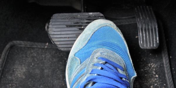 Close-up of a sneaker on the car brake