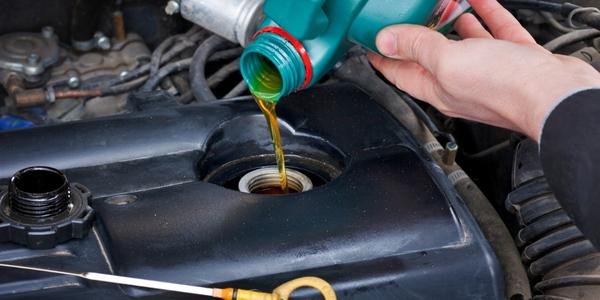 Close-up of oil being added to a car engine