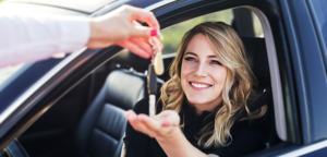 car loan cosigner handing keys to driver
