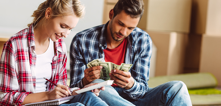 couple discussing building emergency fund or pay off car