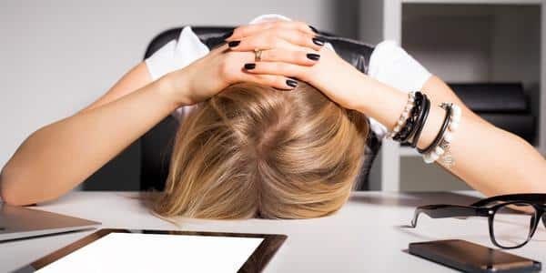 frustrated woman head on desk