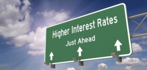 highway sign reading "Higher Interest Rates Just Ahead"