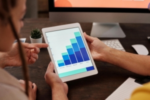 holding tablet showing a graph increasing.