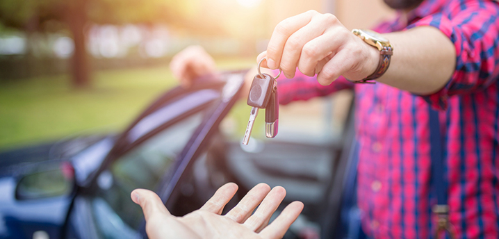 man handing over keys after test drive - trade in vs selling car