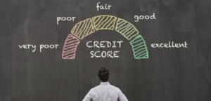 man looking at a credit score on a blackboard