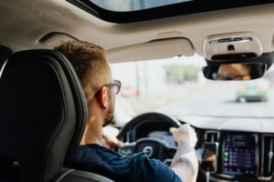 Man driving a car.