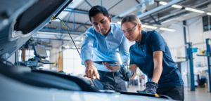 mechanics examining vehicle for repairs