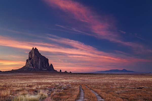 Desert sunset over Shiprock, New Mexico | Top 10 States for Auto Refinance Savings 