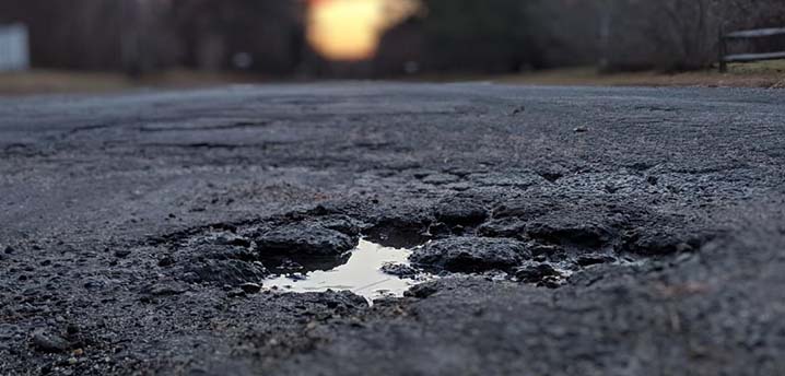 photo of pothole - 718x344 - What Unmaintained Roads Cost the Average Driver in Every State