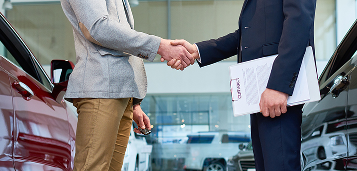 predatory car loans - salesman and buyer shaking hands