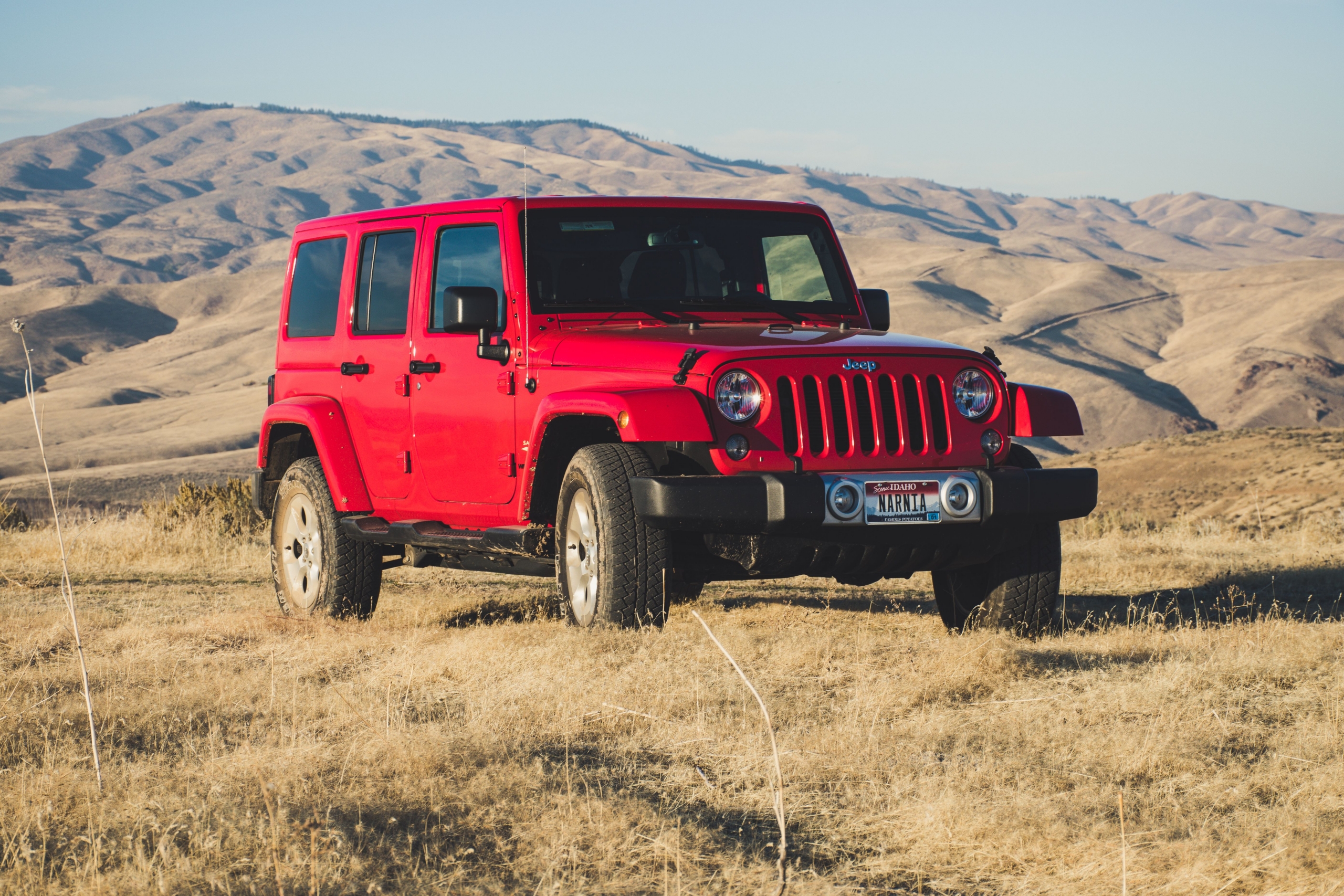 Red Jeep in rolling hills