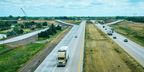 aerial view of highway with cars and semitrucks