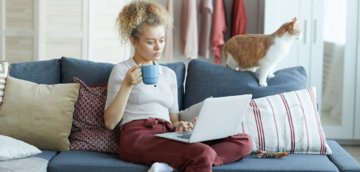 woman researching car loan principal with her cat