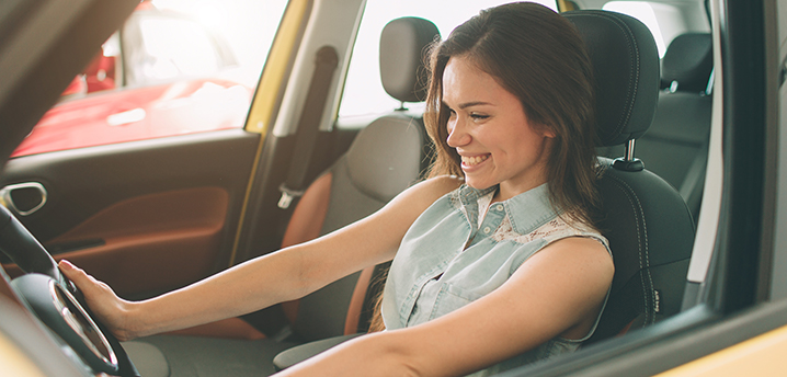 woman sitting in car thinking about what credit score needed to refinance