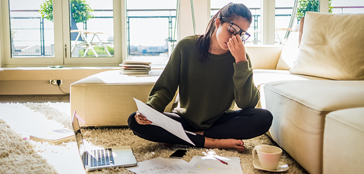 woman stressed choosing between refinancing car loan and trading in car